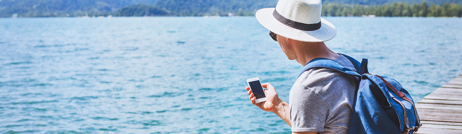 man on vacation looking at phone
